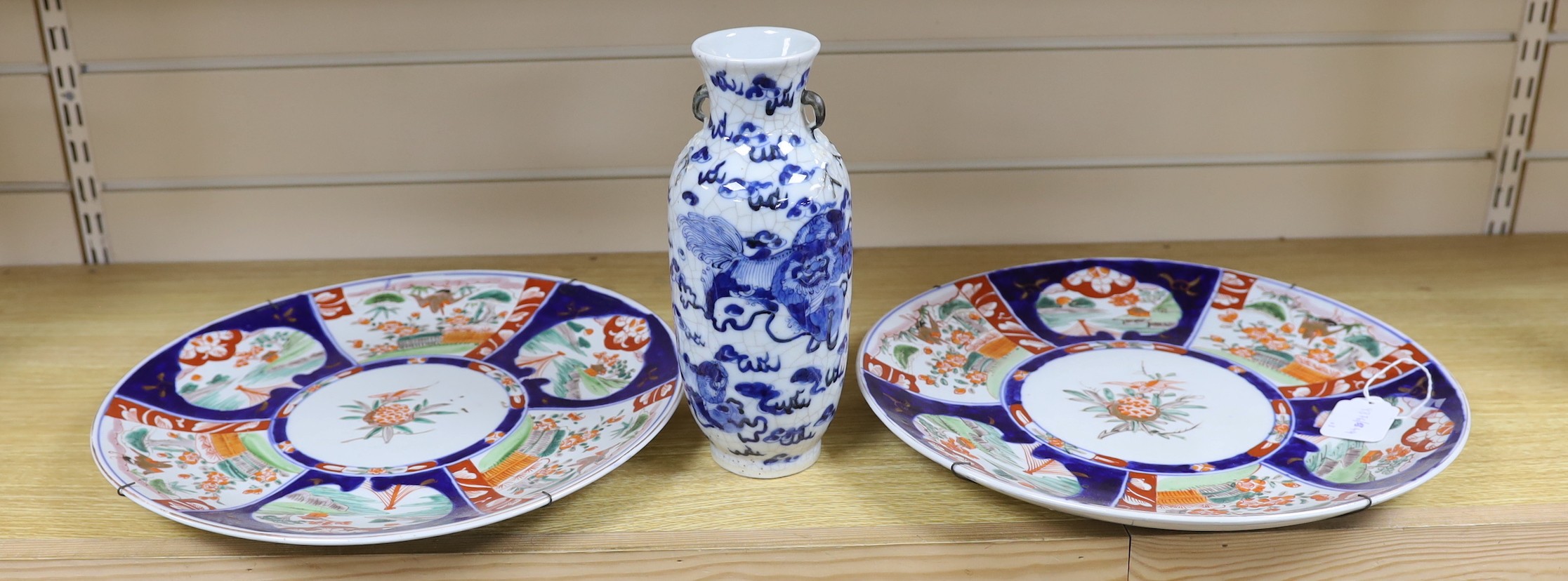 A Chinese two handled crackle glaze vase, Kangxi mark, but late 19th century, together two Imari plates, 37cm diameter